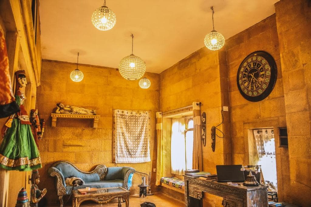 The lounge, with carved sandstone walls and hanging lamps